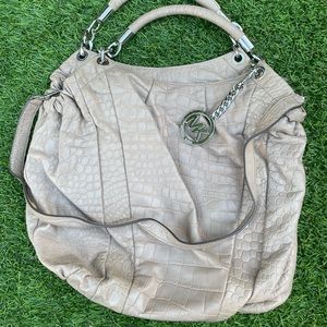 Michael Kors large textured leather cream hobo with over-the-shoulder strap.